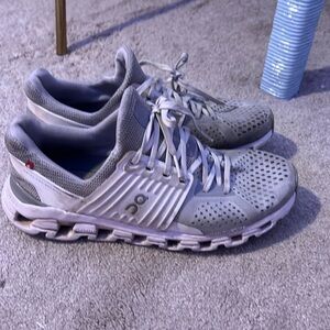Grey on cloud running shoes.  There are 2 holes on the side of each shoe.